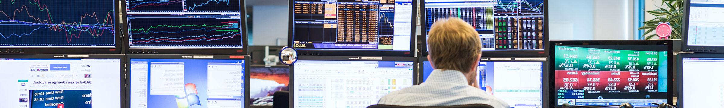 Man in front of monitors